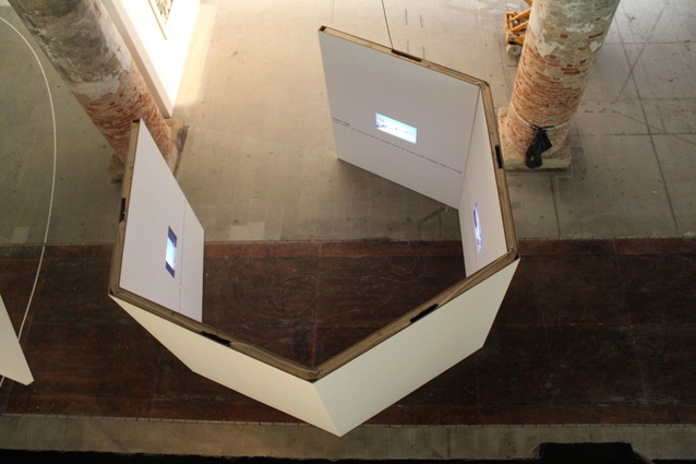 Hexagonal viewing enclosures scattered inside the exhibition at the Corderie.