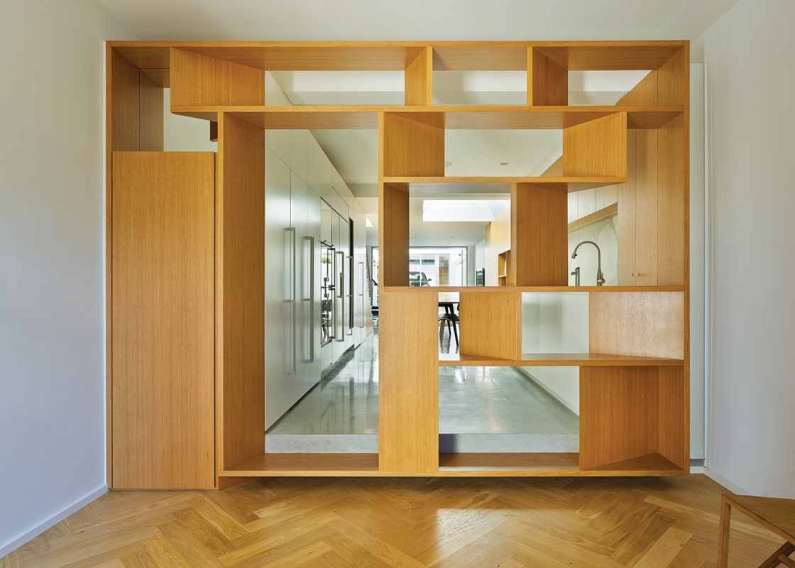 A timber screen-cum-portal acts as a threshold between old and new.