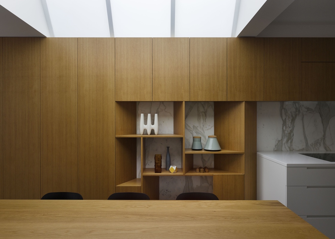The timber joinery element defines space, hides services and provides display space.