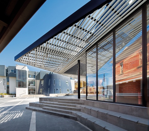 The annexe sits in a back-of-house context, facing an underused plaza.