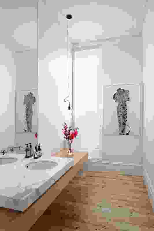 A marble platform hovers above a bench to form the bathroom joinery. Artwork is Plasmagel, 2011, by Doble and Strong.