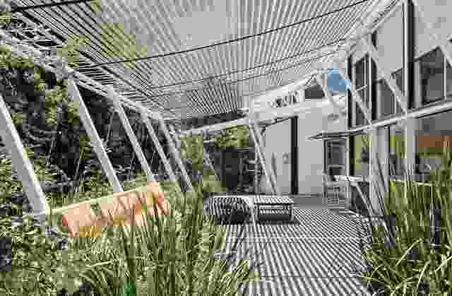 On the northern verandah, netted hammock seats lean in unison with the architecture, appearing to float over and into the landscape.