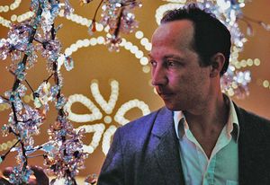 Tord Boontje with his chandelier designed for Swarovski, Blossom.