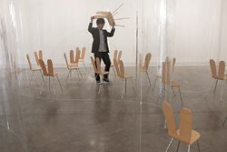 Nishizawa arranging the “Rabbit chairs” (designed by the architects) for the installation.