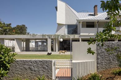 The delicate timber structure of the old Queenslander house has been rotated 90 degrees and raised onto concrete stumps.