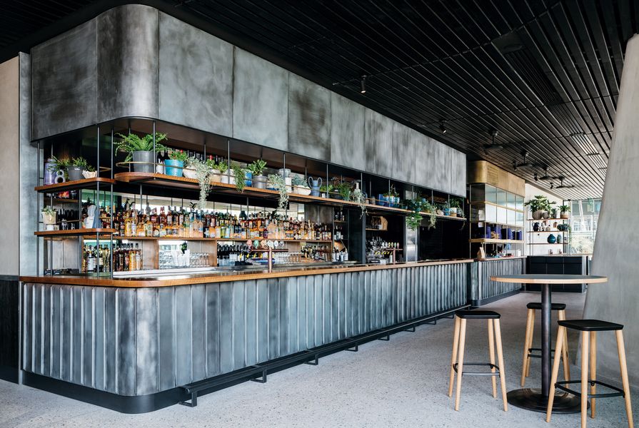 On the ground floor, House Bar features a patinaed copper bar at the rear of the space and seating with views to the harbour.