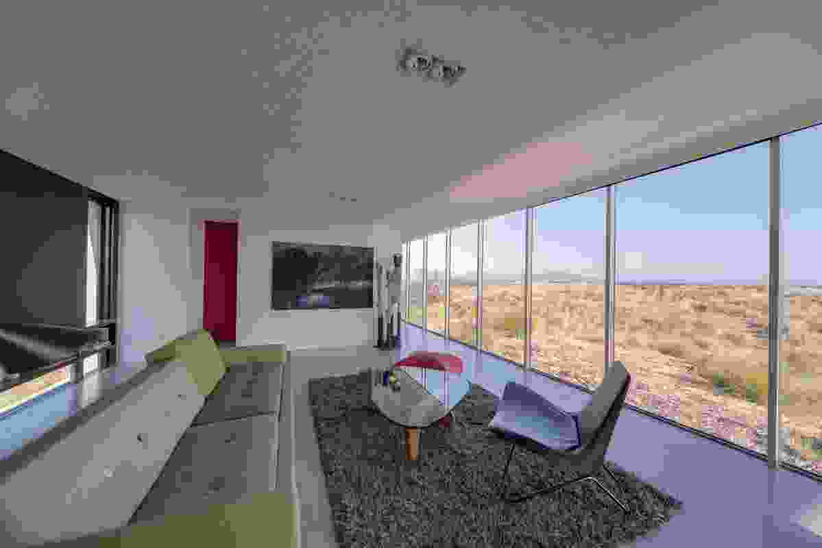 The large windows in the living space look out to the landscape.