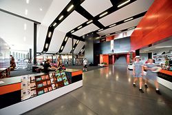 The double-height foyer. “Highway” black ceiling bands flow across and down to drop cabling into the library.