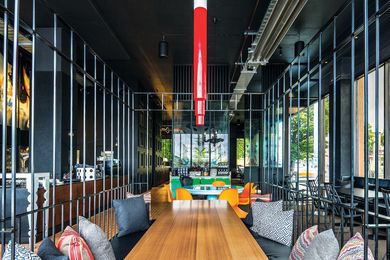 A wrought-iron cage encloses a long timber table.