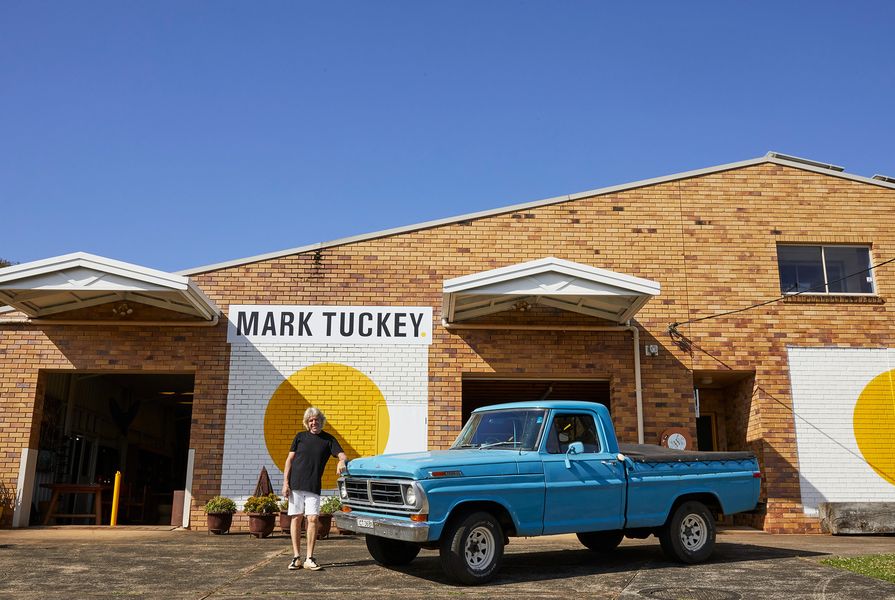 Mark Tuckey with the blue F-100 truck that he used when he first started his business in 1990.