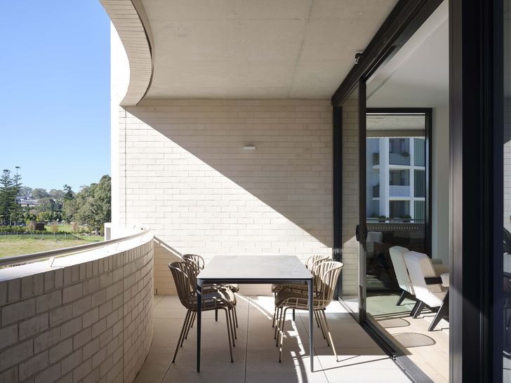 The glazing in the living spaces is angled to face due north-east or north-west, but the curve of the balconies offers a substantial overhang providing solar protection.