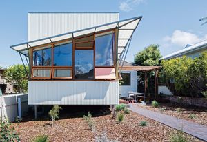 Rather than demolish the original cottage, the designers and their clients opted to refresh
it with an extension that addresses the street and landscape.