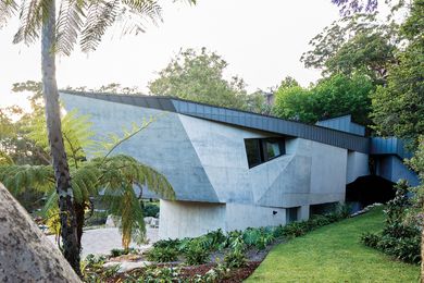 On arrival, visitors encounter a crescent-shaped house with a skin of angular concrete.