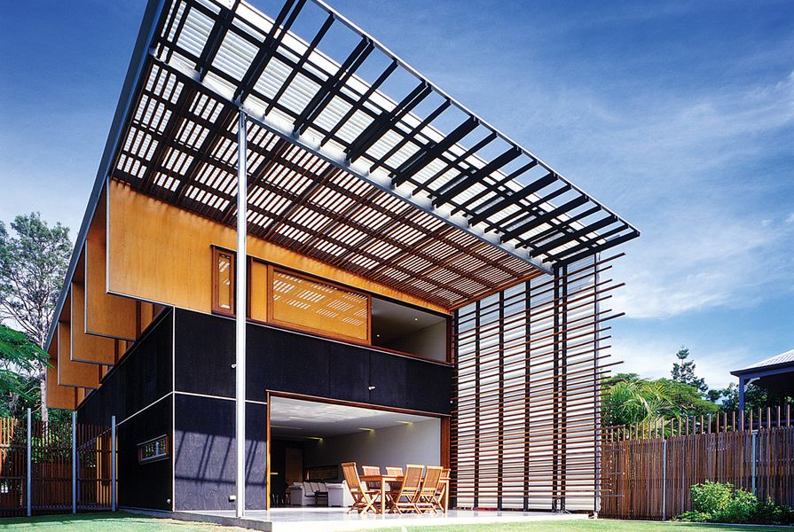 A dramatic outdoor double-height volume gives the modest house a sense of space and gesture.