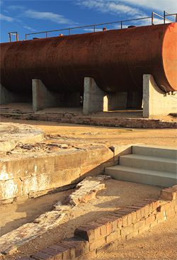 Steel rings mark the position of former oil tanks, one of which has been turned into an architectural folly. Image: Christian Borchert