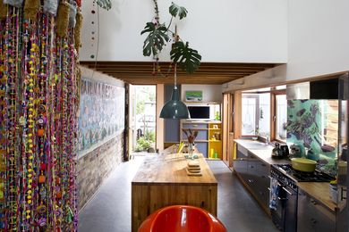 The kitchen with Marmoleum floor, and  recycled brick wall. 