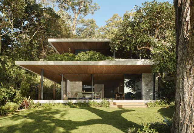 M House by Rama Architects takes shape as a commanding and imposing brutalist form that is softened and subdued by the purposeful act of being embedded within the surrounding landscape.