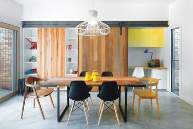 A study nook is cleverly hidden behind a roller door.