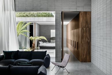 The living space and main bedroom open onto a courtyard garden of swamp banksia and Australian tree ferns.