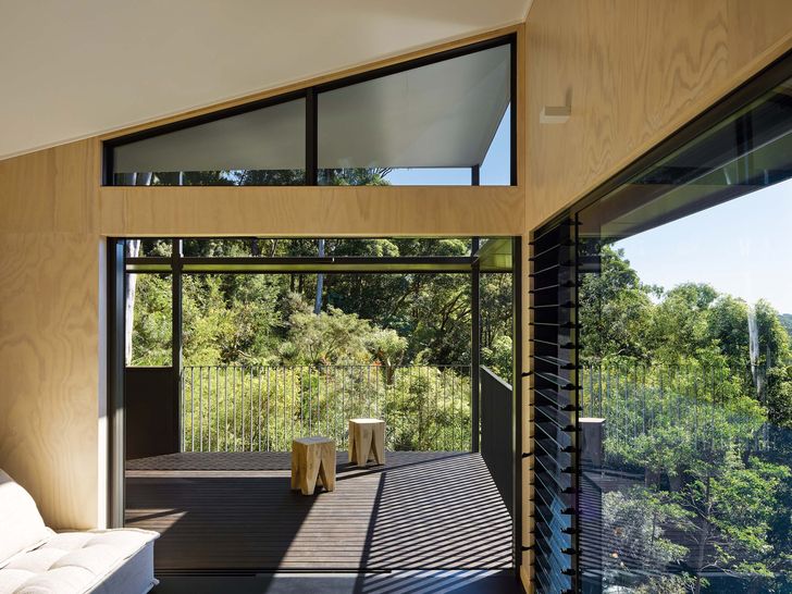 The house appears to nestle into the surrounding hillside and affords views of the Noosa coastline.