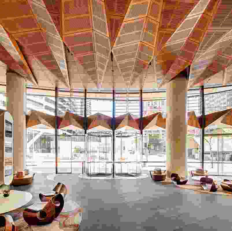  The marine plywood canopy evokes a “line of trees along the edge of the shore,” undulating above the lobby.