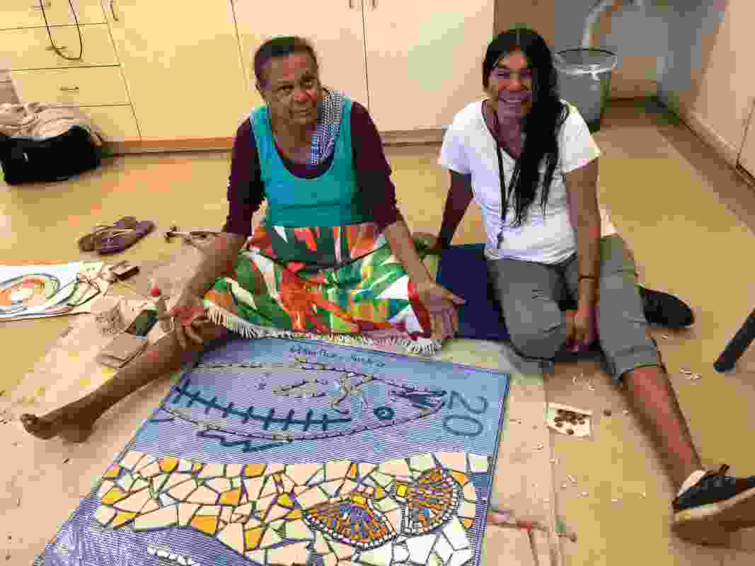 Terricita Corpos and Lorraine Hunter working on a mosaic to be installed at Liyan-ngan Nyirrwa (Cultural Healing Centre).