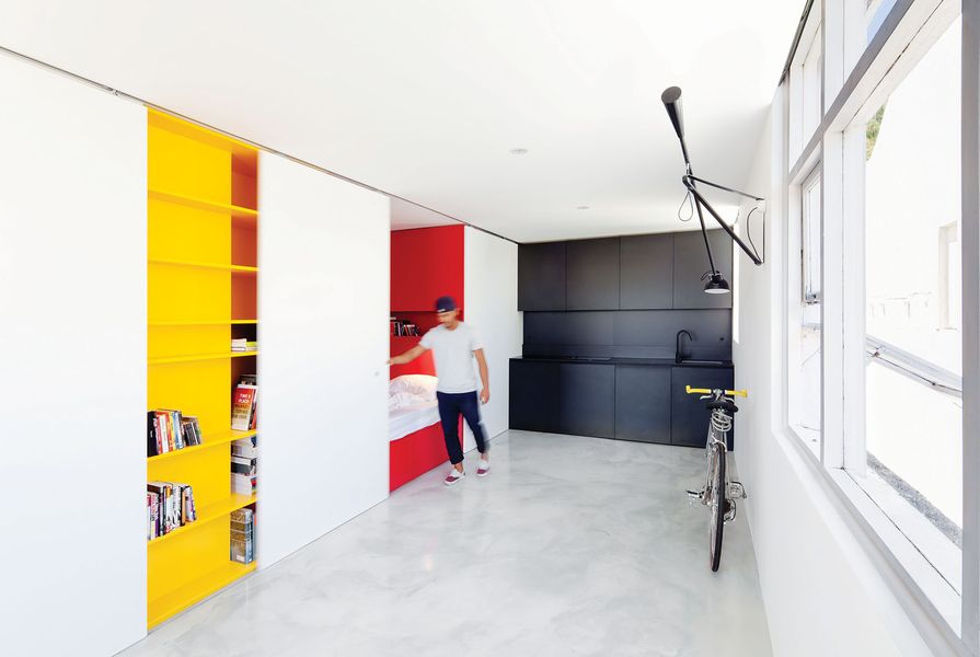 Primary colours are concealed or revealed as the occupant modifies the space with the sliding panels to suit the activity.