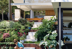 A terraced garden, filled with vegetables, herbs and blooms, descends to the architecture studio on the lower floor of the house.