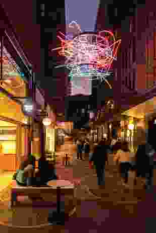 The project’s laneways remain vibrant and inhabited well into the evening when artworks hung between the buildings become illuminated.