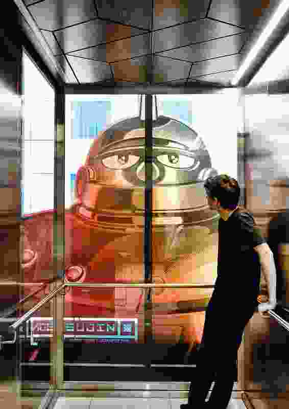 A mural of the Ironman character Tetsujin forms a powerful backdrop in the elevator.