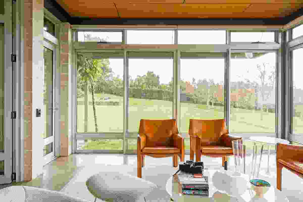 Full-height glazing in the sunroom makes the most of the impressive views of the surrounding landscape.