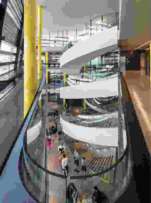 A large atrium and spiralling staircase connect the ground floor to the upper levels and encourage social interaction among students and teachers.
