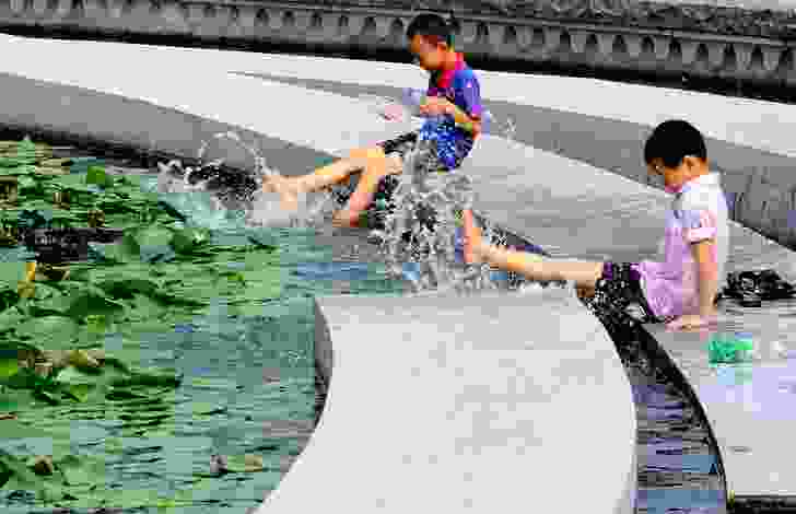 Children splashing in water, Zhangjiagang Town River Reconstruction by Botao Landscape.