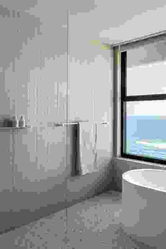 The freestanding bath in the upstairs ensuite is positioned to take in the enviable ocean view.
