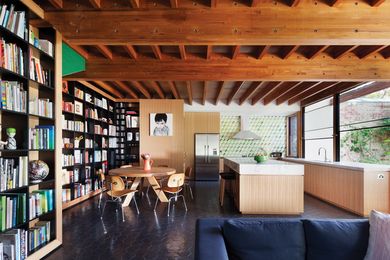 The leafy-green garden view is echoed in the kitchen, where a section of wall is clad with white tiles hand-painted in a geometric green pattern by one of the owners, artist Tai Snaith. Artwork: Cherry Hood.