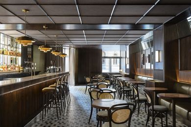 The bar is evocative of a handsome 1920s Chicago-style bar.