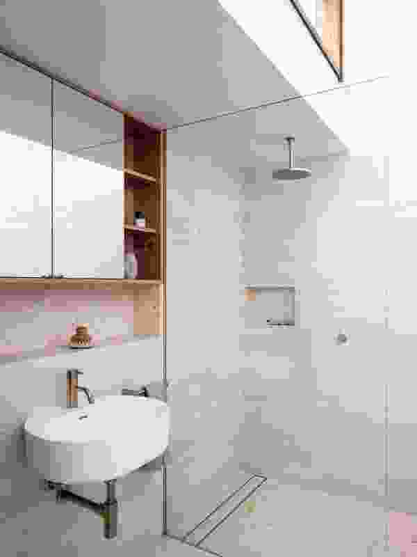 Clerestory windows in the first-floor bathroom enhance the sense of internal volume.