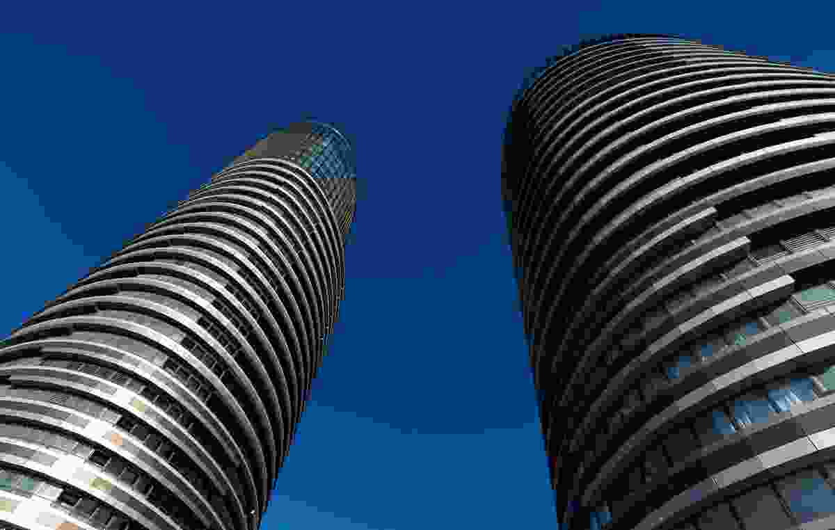 The twin elliptical towers of Australia Towers make for an impressive sight, with alternating striations of glazed surfaces and bronze panels.
