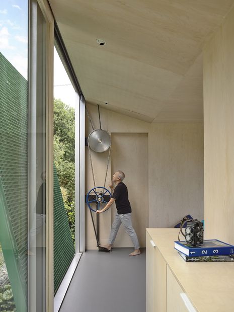 The bridge is hand-powered, connecting the two wings of the house and creating a new circulation path down into the back garden and back inside, below.