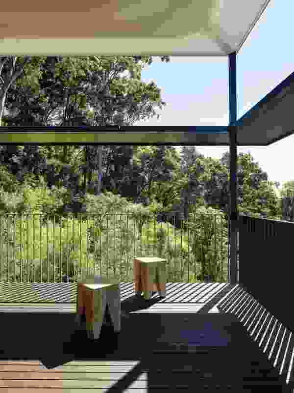 The studio’s compact footprint is augmented by the generous deck among the trees.