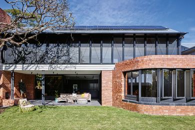 The two-storey extension fits neatly into its garden surrounds, using a large mango tree as a focal point.