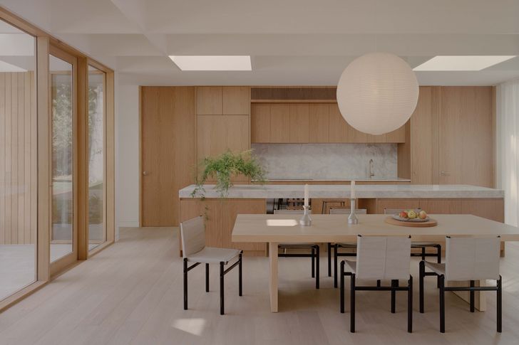 Exposed ceiling rafters align with glazing to achieve a cohesive visual order at Mount Martha House.