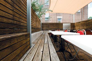 The outdoor deck dining features reclaimed timber benches.