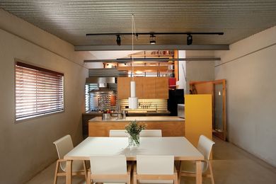 The practical, hoop-pine-clad kitchen lit by concealed downlights.