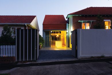 The extension is wrapped in terracotta roof tiles.