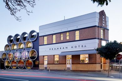 Reinvigorated with a bold facade new rear facade of industrial concrete pipes stacked like kegs or barrels.