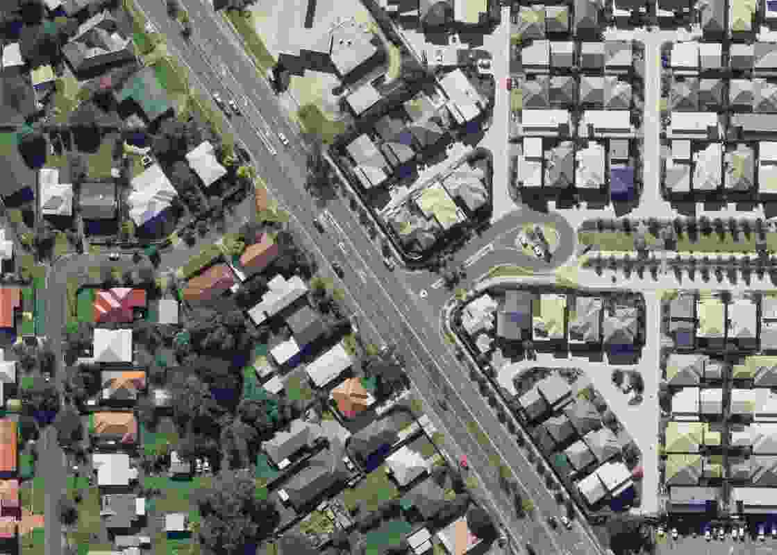 Aerial view showing a housing scheme at Carina, Brisbane, built in 2007–08. Note the older suburban layout with large backyards on the lefthand side of the main road.