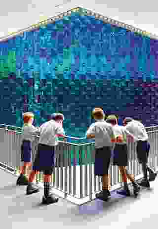The iridescently tiled hub containing the library and information technology spaces references the work of British architect James Stirling.