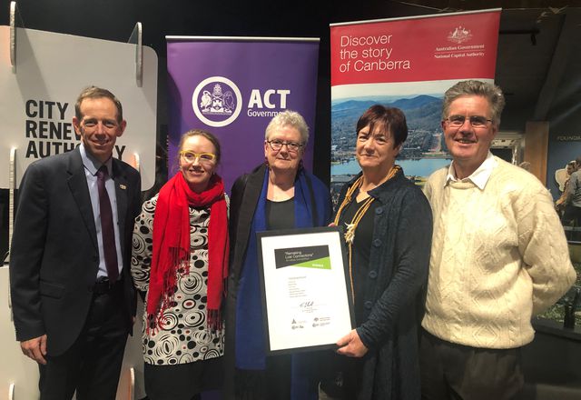 ACT Minister for Climate Change and Sustainability, Shane Rattenbury, presents the ‘Stomping Grounds’ with their award.