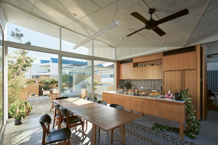 A skewed butterfly roof rises and falls to create varied volumes.